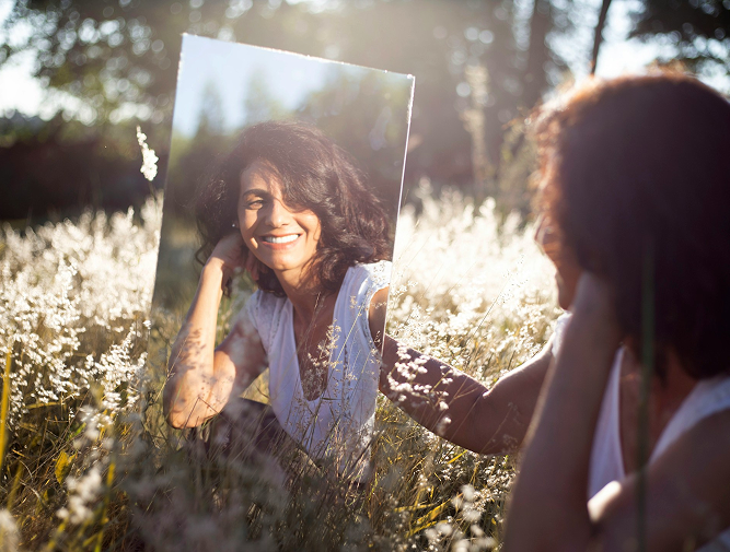 Woman Looking Into A Mirror