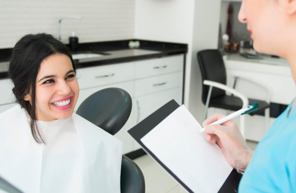 Woman Smiles As She Checks In With Her Orthodontist