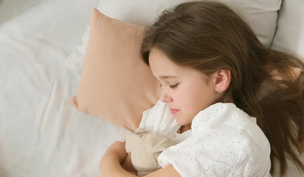 A Girl Sleeping In Bed