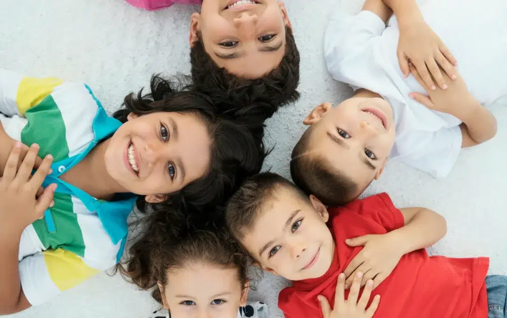 A Group Of Happy Kids On A Floor
