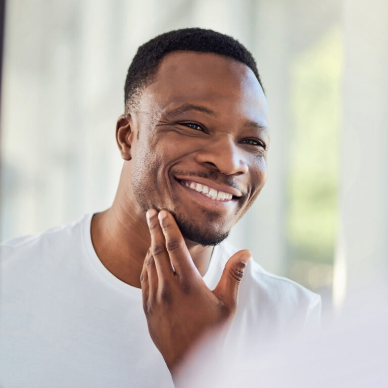 Man Smiling Looking At Himself In Mirror 2