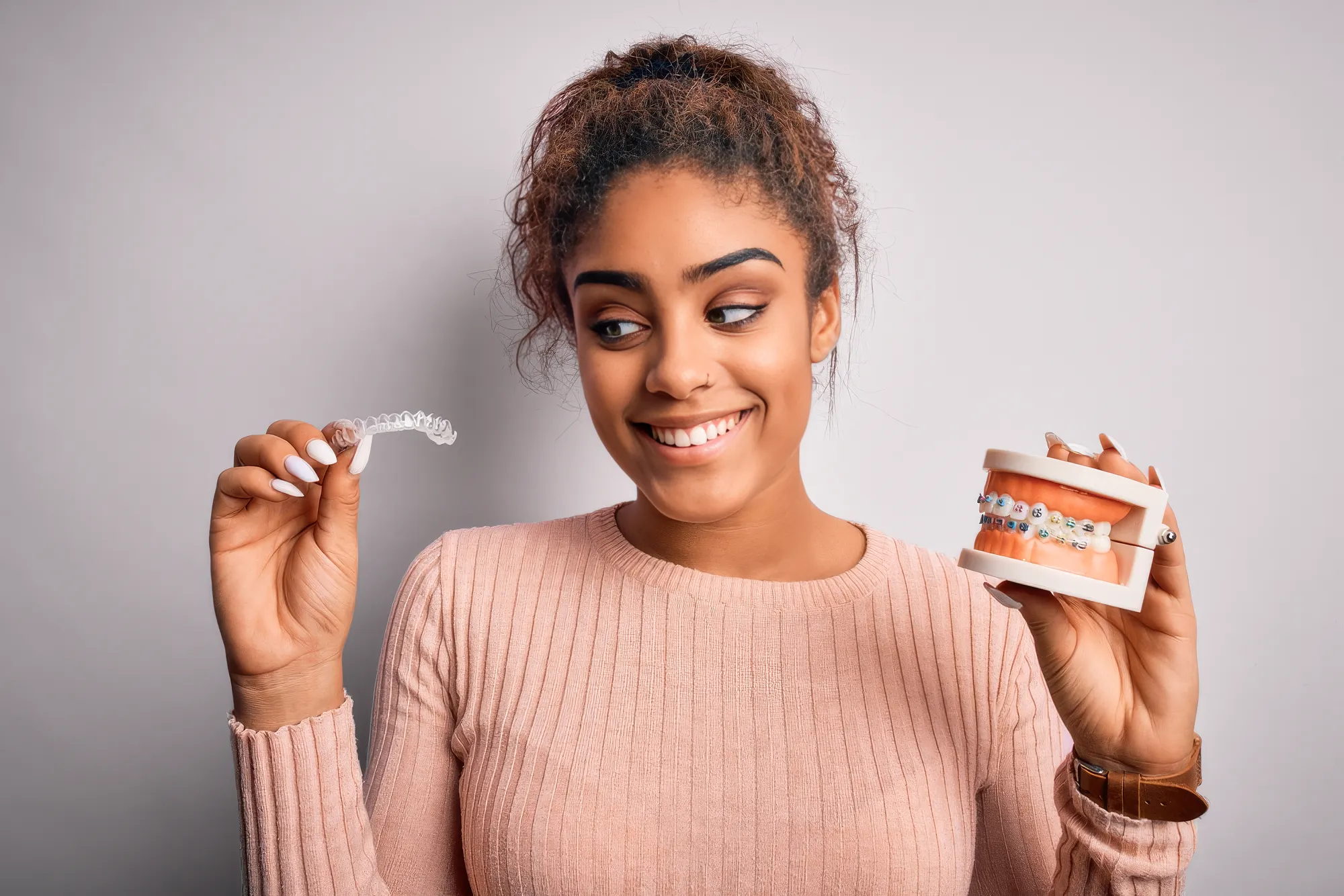 A Woman Deciding Between Invisalgin And Braces